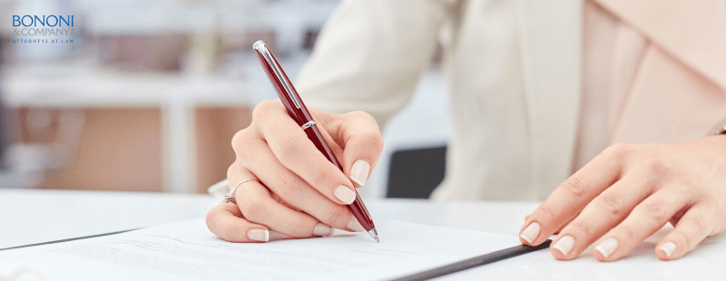 woman signing a document