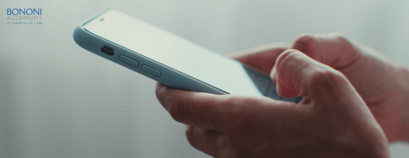 hands typing on a cell phone. sending a text message