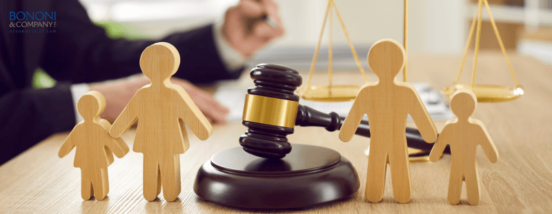 gavel sitting on attorney's desk with family figures surrounding it. discussing child custody